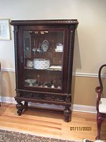 Full view of china cabinet against wall showing overall design and contents not included