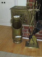 All items grouped: brass storage box, scuttle bucket with ceramic handles, fireplace tool set and bellow on stand.