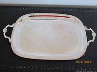 Full front view of the rectangular silver plated tray showing overall shape, handles, and surface engraving.