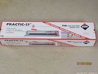 Box showing full product and branding with the tile cutter's image and main features.