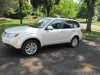 Front-driver side angled view showing exterior body, wheels and roof rack.
