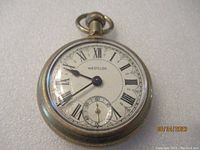 Front view of Westclox pocket watch showing white dial with black Roman numerals and sub seconds dial.