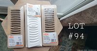 Photo of the set of three new air vents, two beige and one white, each 3 in x 10 in, in original packaging with HDX labels visible.