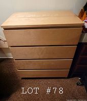 Front view of the Ikea Malm dresser showing all 4 drawer fronts and overall condition.