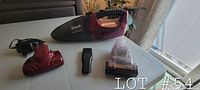 Full lot of Shark cordless handheld vacuum, attachments, and charger on a table.