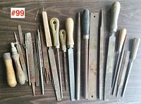 Full view of 14 assorted metal files and rasps with various wooden and plastic handles