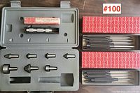 Plastic case with 7 metal center punches of varying sizes and shapes, arranged inside the case with cutouts for each punch.