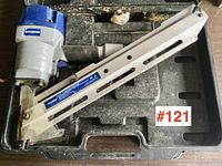 Full view of the Hyundai pneumatic framing nailer inside its carrying case showing the entire tool and case condition.