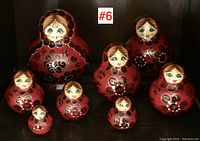 Full view of all seven Russian nesting dolls, showing the graduated sizes and consistent hand-painted floral designs and female faces.