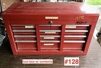 Closed red tool chest showing wear, scuffs, and 'RPC' markings, with label 'tool box w/ contents #128'