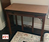 Closed console-sized walnut banquet table with two drawer pulls and straight legs.