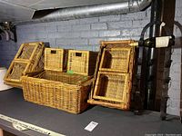 Nine wicker baskets displayed including small square, medium rectangular, and large rectangular ones. Light brown woven wicker.