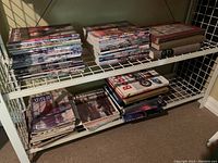 Shelving unit holding multiple stacks of magazines and books; magazines include American Art Review issues, and there are some hardcover books.