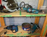 Photo of shelving with circular saw, Makita die grinder with bits, Bosch power drill, Makita disc grinder with sanding discs