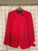 Red mens blazer jacket hanging on rack showing full front with black grid web pattern