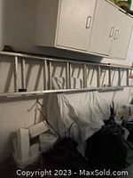 8-foot extendable ladder horizontally mounted on wall, showing metal construction and condition.