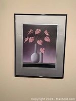 Framed art print with stylized pink leaves in vases against black background.