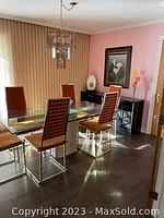 Full view of glass-top table with six chairs in dining room