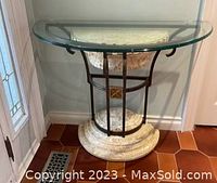 Front view of the console table showing glass top, metal frame, and marble base