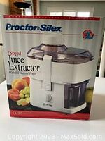 Proctor-Silex juice extractor boxed with product image and specifications on box.