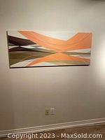 Canvas wall art hung on plain wall, showing full artwork with warm toned abstract geometric shapes in orange, brown, and beige.
