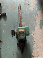 Top view of Weed Eater Excalibur hedge trimmer lying flat, showing full length of blades and body.