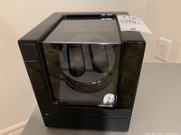 Front view of black Triple Tree watch winder showing clear viewing window and black glossy finish.