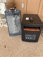 EdenPURE 1000XL quartz heater and Holmes heater side by side on floor.