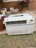 Front view of LG window air conditioner showing powered vent, control buttons, and rust spots.