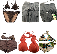 Photo showing six swimsuits including black patterned bikini, grey ruffled tankini, brown shorts and top, red bikini top, floral bikini
