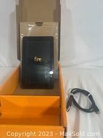 Amazon Fire 7 tablet in original packaging box with 'fire' branding visible on tablet back panel.