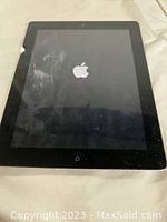 Front view of iPad 2 showing screen and Apple logo on loading screen