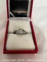 Topaz stacking ring set in its red Alfred Durante box showing the ring with multiple clear stones on silver-tone metal.