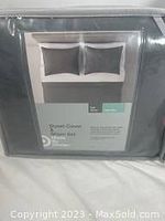Photo showing front packaging of the duvet cover and sham set with branding and care info visible.