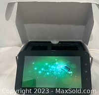 Android tablet powered on, screen shows Android start-up with green abstract background.