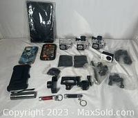 Wide view of all items including camera covers, sports cameras, phone and tablet cases, mag lights, and camera accessories.