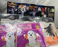 Photo showing 3 Super Value Makeup Sets in packaging and 2 inflatable ghost ring toss games sealed in plastic