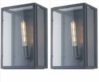 Two identical industrial style glass wall sconces with matte black square frames and smoked glass panels. Each has a tall vintage filament bulb inside.