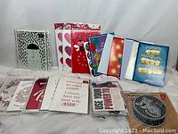 Assortment of greeting cards showing a variety of cover designs including umbrellas, hearts, cupcakes, and celebratory themes.