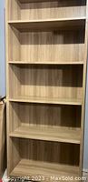 Full view showcasing all five shelves of the natural wood bookcase with wood grain finish and smooth edges.