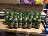 Multiple vintage Mountain Dew glass bottles showing front label and arrangement