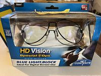 Sealed box of HD Vision Special Ops Blue Light Block glasses with aviator style, black metal frames visible through plastic display window.