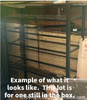 Front angled view of black zinc steel shelving unit with wire shelves and pegboard background, showing size and structure.