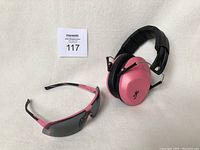 Photo of Browning pink electronic ear muffs and pink shooting glasses on a plain background.