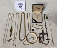 Overview photo showing the entire collection of vintage jewelry including chains, bracelets, brooch, cross pendants, and earrings.