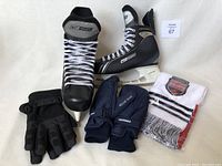 Overview of all items: Bauer size 12 skates, gloves, mittens, and Hometown Hockey scarf.