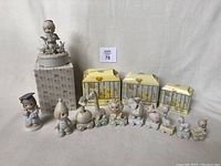 Photo showing all Precious Moments figurines including Birthday Train series from ages baby to 8 with some original boxes, plus graduate and musical figurines