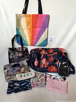 Full view of all bags and purses in the collection against white background.