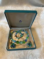 Set shown inside original blue Birch box with satin lining, containing necklace and earrings.
