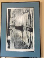 Full view of the black and white framed print showing a Venice canal with a gondola and surrounding buildings.